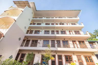 an apartment building with balconies and windows at G house guest house in Patong Beach