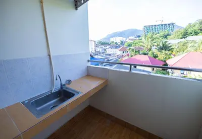a bathroom with a sink and a window at G house guest house in Patong Beach