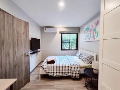 a small bedroom with a bed and a window at 2 Bedrooms Suite Pool Access@The Title Residencies Naiyang in Nai Yang Beach