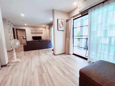 a living room with a couch and a large window at 2 Bedrooms Suite Pool Access@The Title Residencies Naiyang in Nai Yang Beach