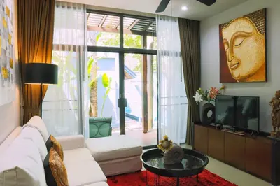 a living room with a white couch and a tv at Villa Casablanca in Ban Saiyuan (1)