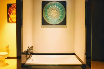 a bathroom with a bath tub and a toilet at Villa Casablanca in Ban Saiyuan (1)