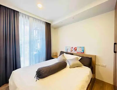 a bedroom with a bed with a large window at Sky park 2 BR lake view in Bang Tao Beach