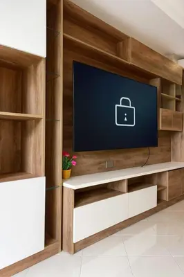 a living room with a tv on a wooden wall at Aksarai hotel in Patong Beach