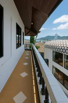 a balcony with a view of a building at Aksarai hotel in Patong Beach