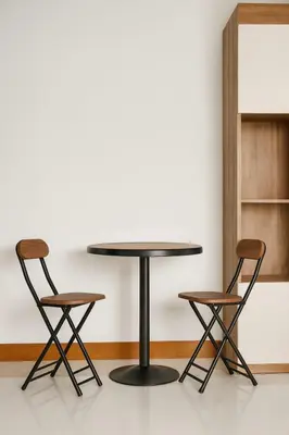 a table and two chairs in a room at Aksarai hotel in Patong Beach