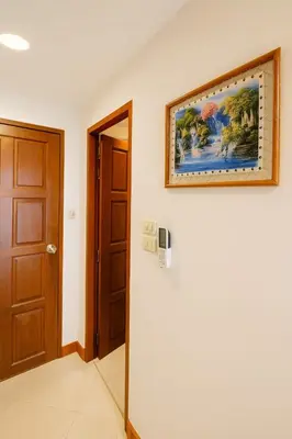 a room with a painting on the wall and a door at Aksarai hotel in Patong Beach