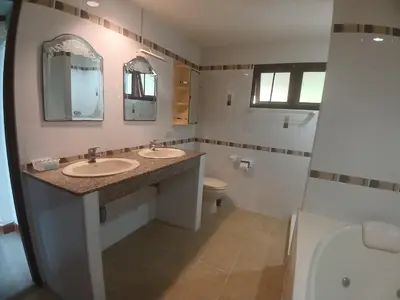 a bathroom with two sinks and a toilet at Aksarai hotel in Patong Beach