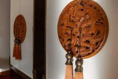 a wooden clock hanging on a wall at Saitaan,4BR seaside garden pool villa, Laguna area in Bang Tao Beach