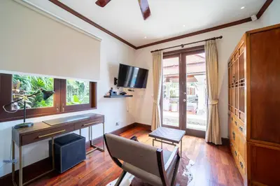 a living room with a desk and a chair at Saitaan,4BR seaside garden pool villa, Laguna area in Bang Tao Beach