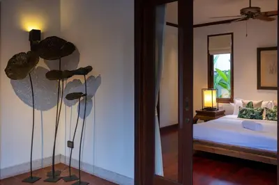 a room with a bedroom with a bed and a mirror at Saitaan,4BR seaside garden pool villa, Laguna area in Bang Tao Beach
