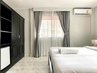 a bedroom with a bed and a window at Minotel Patong in Patong Beach