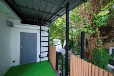 a house with a porch with green grass at Modern & fun pool villa at Kamala regent in Kamala Beach