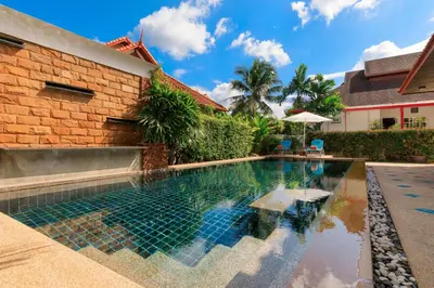 a swimming pool in front of a building with a house at Villa with pool, garden and terrace - Kamala #123 in Phuket Town