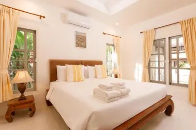 a bedroom with a bed with towels on it at Villa with pool, garden and terrace - Kamala #123 in Phuket Town
