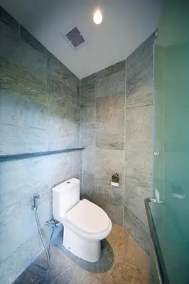 a bathroom with a white toilet in a room at Beyond Skywalk Nangshi in Ban Met Nang Chi