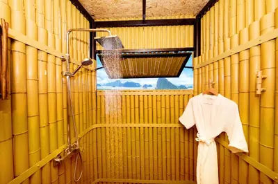 a bathroom with a shower and a robe on a hanger at Beyond Skywalk Nangshi in Ban Met Nang Chi