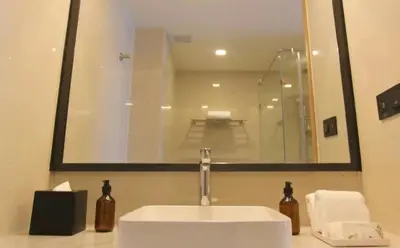 a bathroom with a white sink and a mirror at Water park Rawai Beach 200m Nai Han king bedroom in Rawai Beach