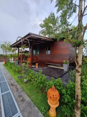 a small house with a fire hydrant in front of it at Baan Ati Resort & Spa in Ban Na Tai