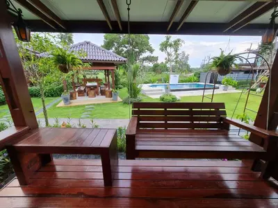 a porch with a bench and a gazebo at Baan Ati Resort & Spa in Ban Na Tai