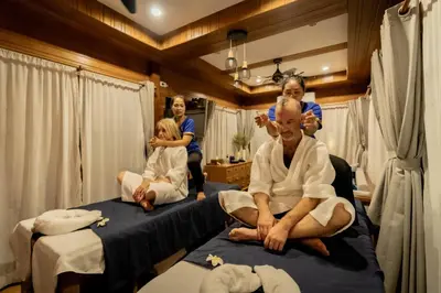 a group of people sitting on beds in a room at Baan Ati Resort & Spa in Ban Na Tai
