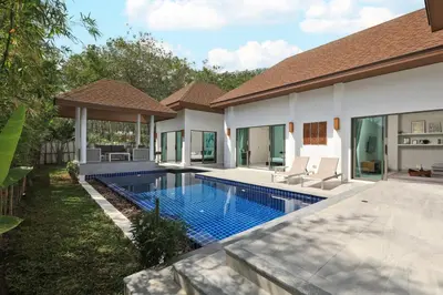 a swimming pool in the backyard of a villa at 4bdr Pool Villa Suksan Rawai by CapitalPro SUK-20-154 in Phuket Town