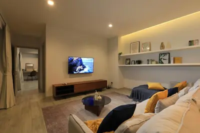 a living room with a couch and a tv at 4bdr Pool Villa Suksan Rawai by CapitalPro SUK-20-154 in Phuket Town