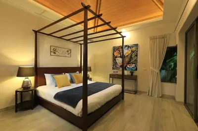 a bedroom with a canopy bed in a room at 4bdr Pool Villa Suksan Rawai by CapitalPro SUK-20-154 in Phuket Town