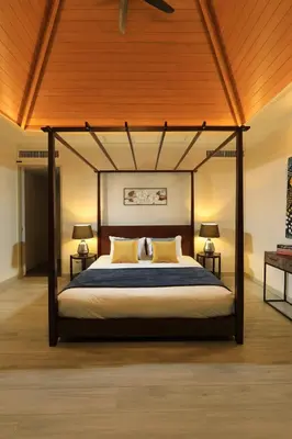 a bedroom with a canopy bed with two lamps at 4bdr Pool Villa Suksan Rawai by CapitalPro SUK-20-154 in Phuket Town