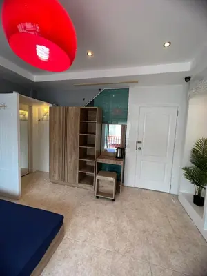 a room with a desk and a red light at Petunya Room 2 in Ban Huai Luk (1)
