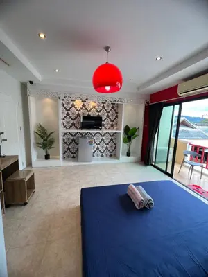 a bedroom with a blue bed and a fireplace at Petunya Room 2 in Ban Huai Luk (1)