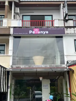 a window of a building with a sign on it at Petunya Room 2 in Ban Huai Luk (1)