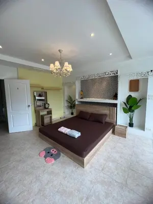 a bedroom with a large bed in a room at Petunya Room 1 in Ban Huai Luk (1)