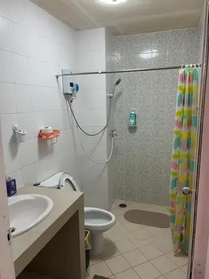 a bathroom with a shower and a toilet and a sink at Petunya Room 1 in Ban Huai Luk (1)