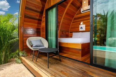a room with a bed and a chair on a deck at Tropical Chalet 2BR Villa Pasak Paradise 1 with Private Pool, Laguna 10 min drive in Bang Tao Beach