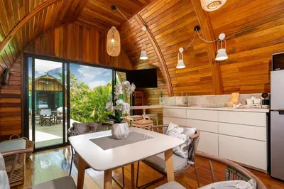 a kitchen and dining room with wooden walls and a table at Tropical Chalet 2BR Villa Pasak Paradise 1 with Private Pool, Laguna 10 min drive in Bang Tao Beach