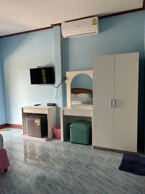 a bedroom with a bunk bed with a tv on the wall at Adam Bungalows in Ao Nang Beach