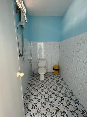 a bathroom with a toilet in a blue and white tiles at Adam Bungalows in Ao Nang Beach