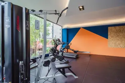 a room with a gym with two tread machines at The Tower Condo Phase3 in Ban Klang