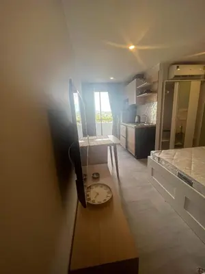 a small kitchen with a clock on a table at The Tower Condo Phase3 in Ban Klang
