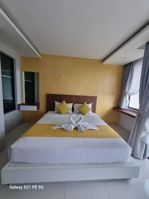 a bedroom with a large bed with a bow on it at 1 Bedroom Rawai Walk to beach in Rawai Beach