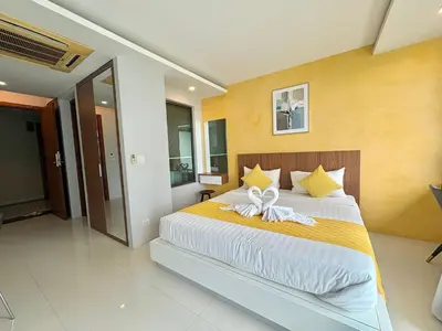 a bedroom with a bed with a bow on it at 1 Bedroom Rawai Walk to beach in Rawai Beach