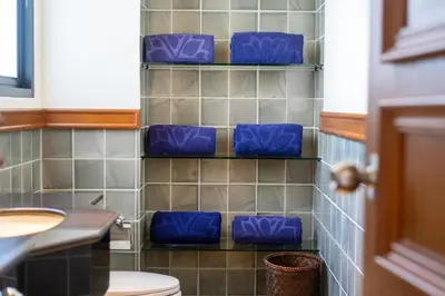 a bathroom with blue seats on a tiled wall at Angsana Villas Laguna-3 Bedroom Pool Villa in Phuket Town