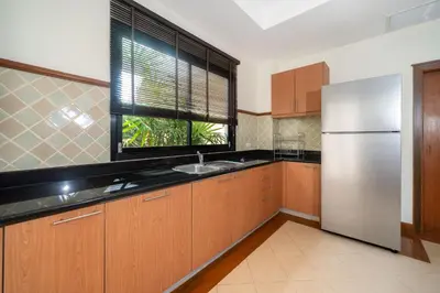 a kitchen with a stainless steel refrigerator and a window at Angsana Villas Laguna-3 Bedroom Pool Villa in Phuket Town