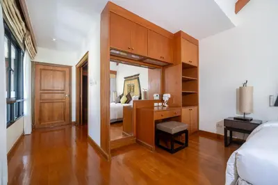 a bedroom with a bed and a desk and a bed at Angsana Villas Laguna-3 Bedroom Pool Villa in Phuket Town