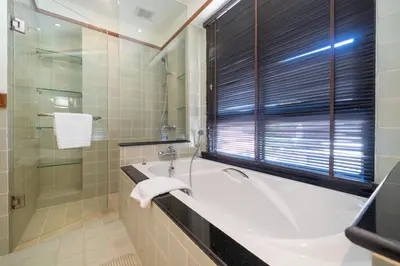 a bathroom with a bath tub and a window at Angsana Villas Laguna-3 Bedroom Pool Villa in Phuket Town