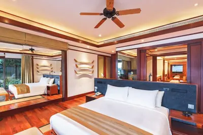 a bedroom with two beds and a ceiling fan at Andarada Seaview in Kamala Beach