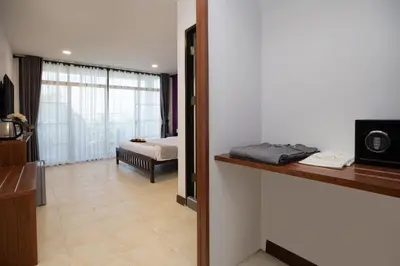 a room with a bedroom with a bed and a window at Aspira Resort Klong Muang Krabi in Klong Muang Beach