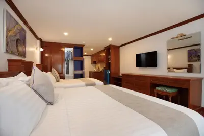 a hotel room with two beds and a flat screen tv at Aspira Resort Klong Muang Krabi in Klong Muang Beach