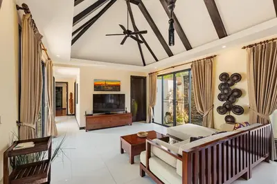 a living room with a couch and a tv at Secret Balinese Escape villla Eva in Rawai Beach